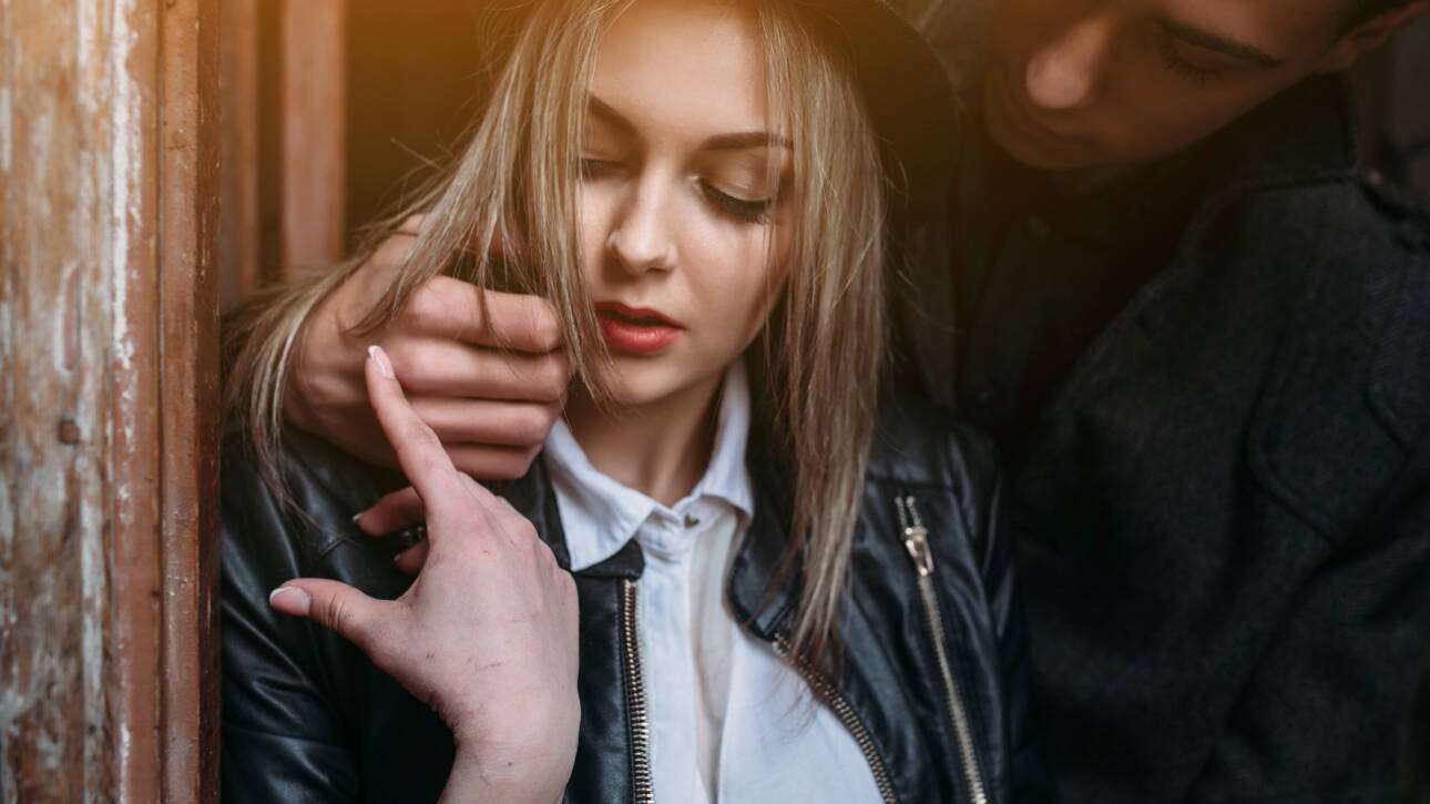 Person appearing distressed during a tense and controlling interaction in a relationship