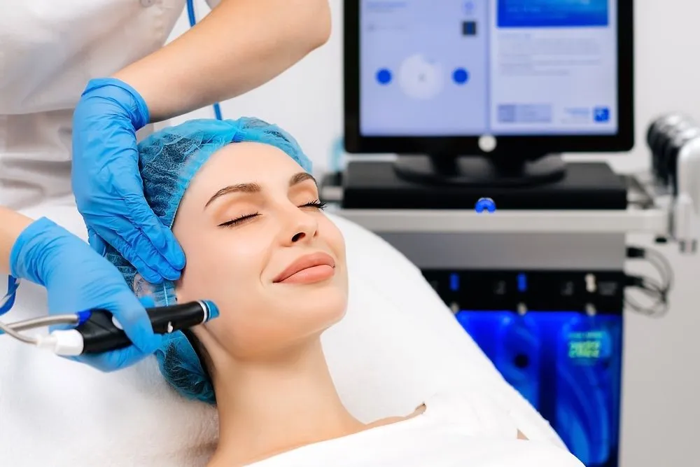Hydrafacial Fairfax VA treatment with a licensed skincare professional performing a non-invasive facial using advanced hydrafacial technology for glowing skin.