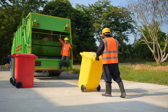 Trash Removal Services Kent WA workers collecting residential waste with color-coded garbage bins and a rear-loading garbage truck.